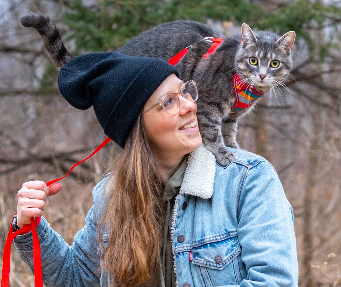 Woman with a cat in harness
